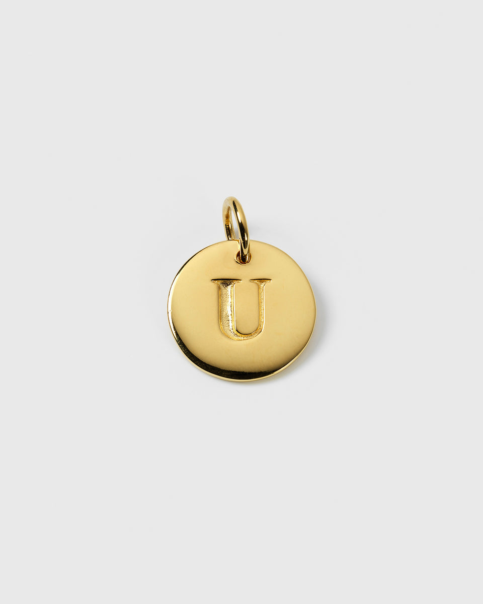 A product shot of the Beloved Big Letter pendant in gold, featuring a circular charm with the letter 'U' engraved on it.