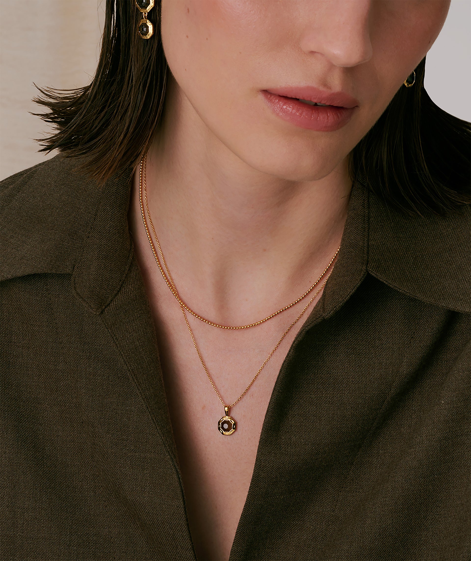 Two necklaces – one is a basic chain, and the other has a pendant set with a faceted smoky quartz in a hammered setting.