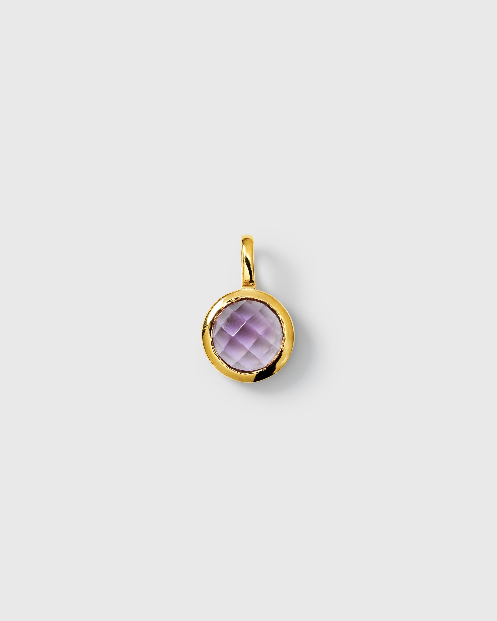 Gold pendant featuring a round faceted amethyst, February birthstone.