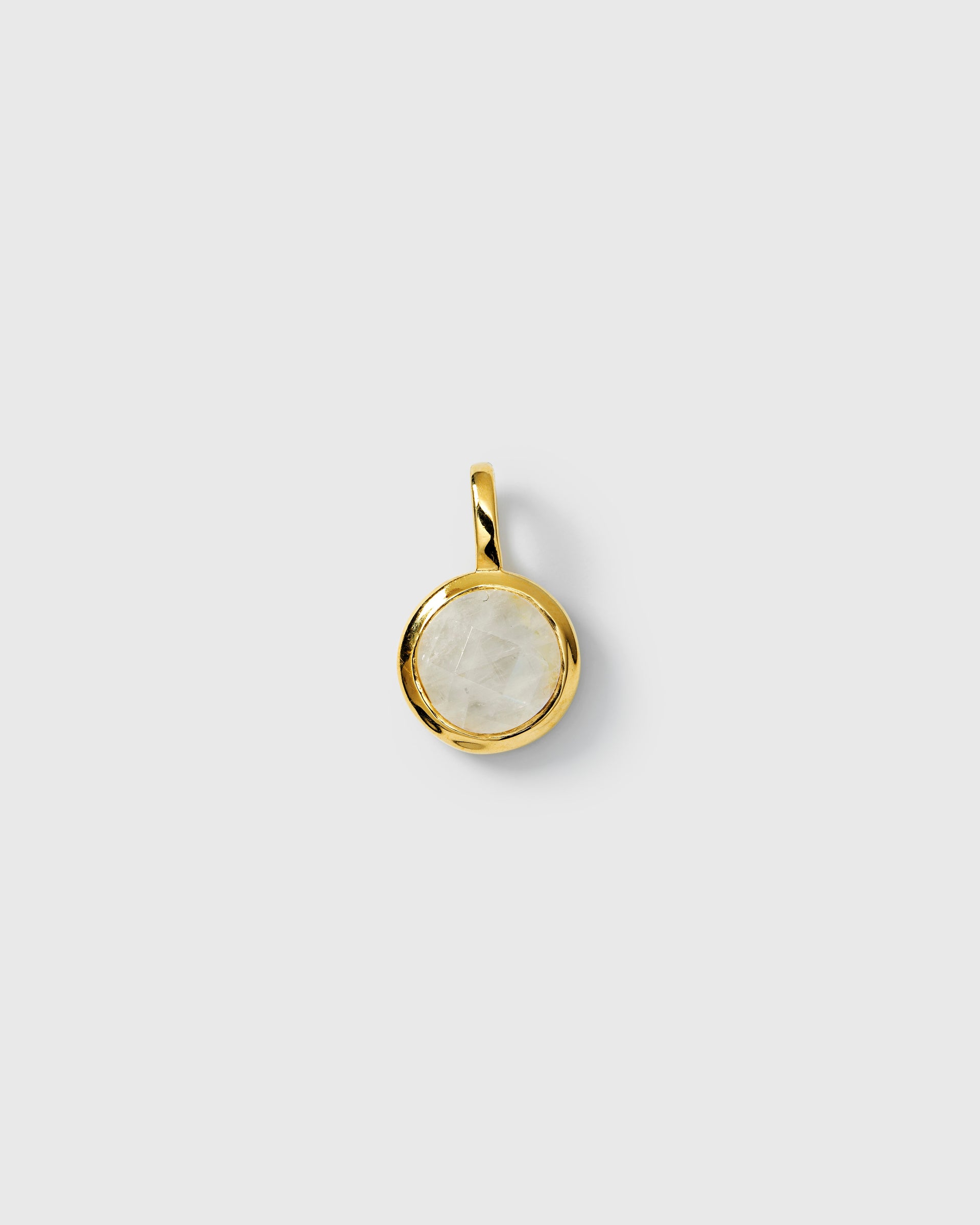 Gold pendant featuring a round moonstone, June birthstone.