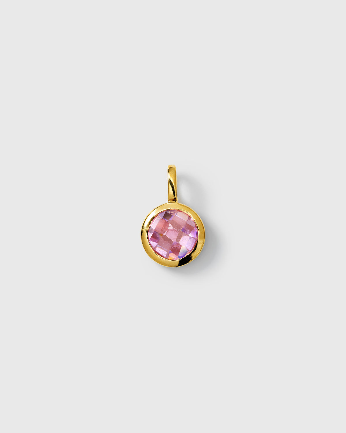 Gold pendant featuring a round faceted pink tourmaline cubic zirconia, October birthstone.