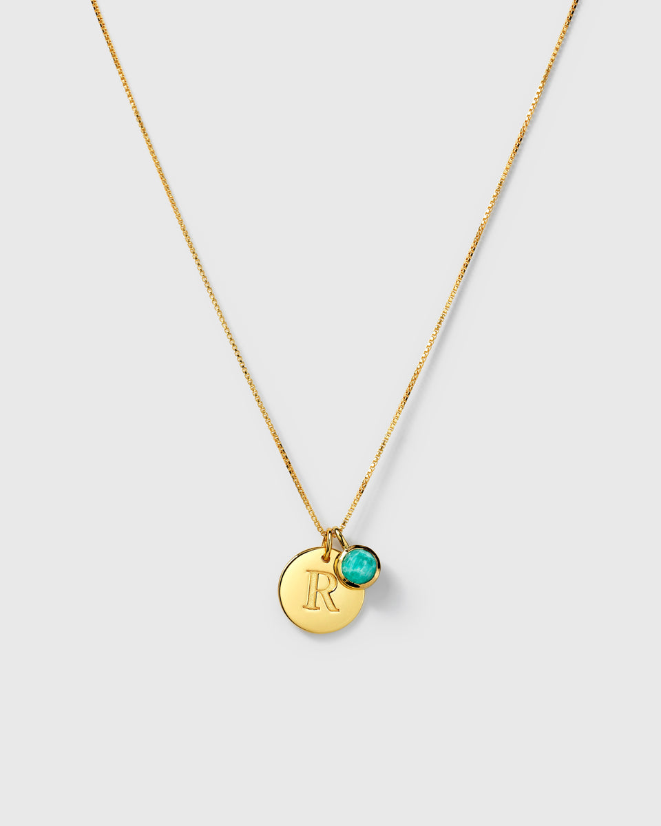 Gold necklace with letter pendant and December birthstone turquoise amazonite charm.