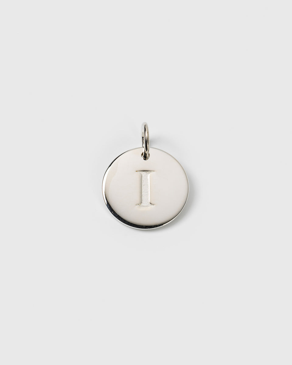 A product shot of the Beloved Big Letter silver charm, featuring a round pendant with the letter 'I' engraved on it.