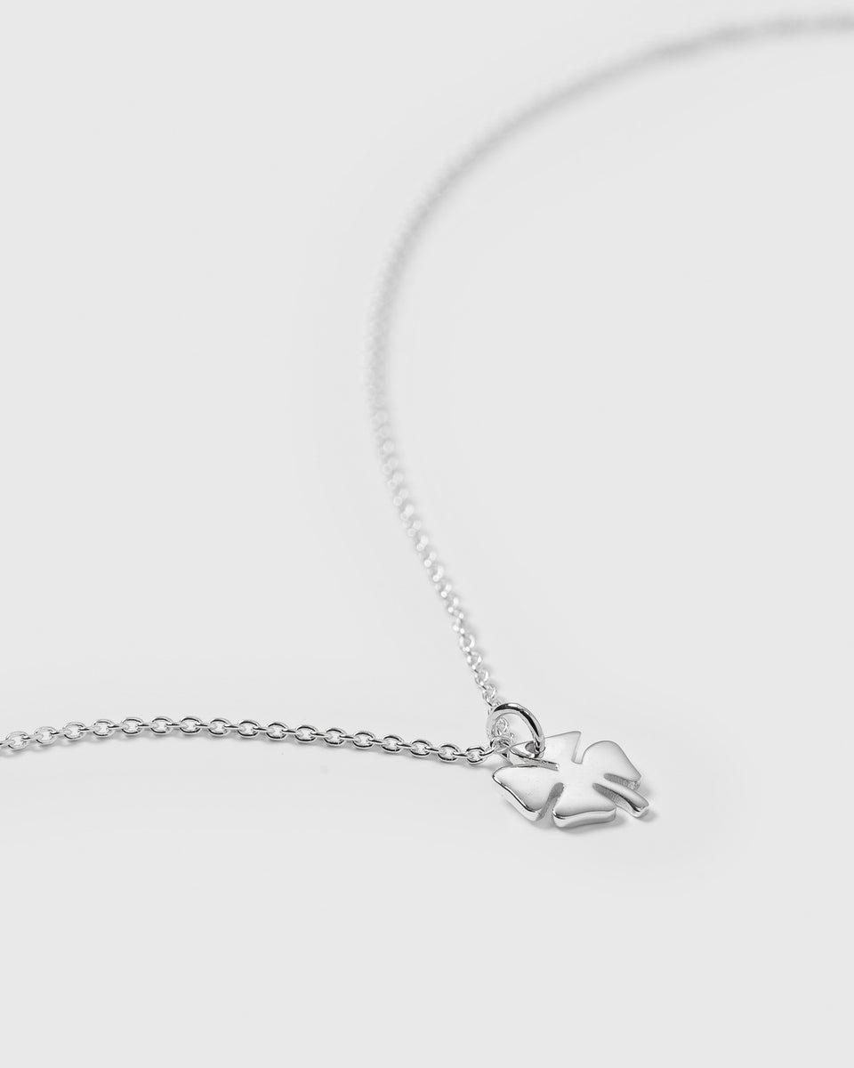 A product shot of the Bring Me Luck Necklace in silver, featuring a fine chain and a small four-leaf clover pendant.