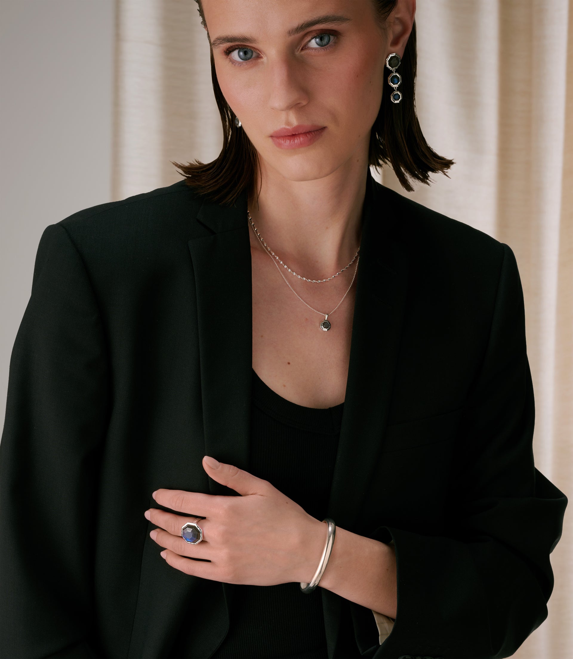 A bold sterling silver look, including both bangles, necklaces, earrings, and rings.