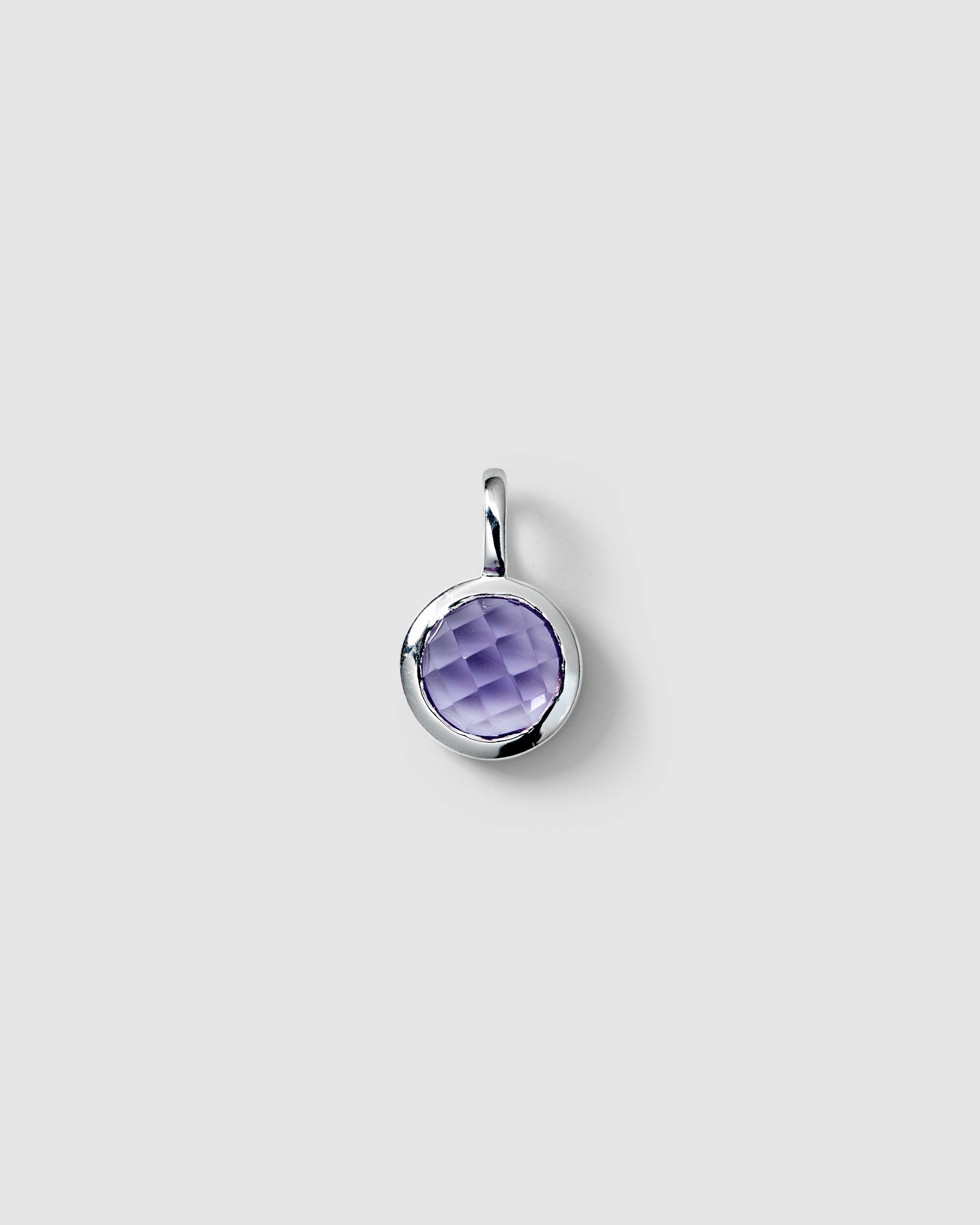 Silver pendant featuring a round faceted amethyst, February birthstone.