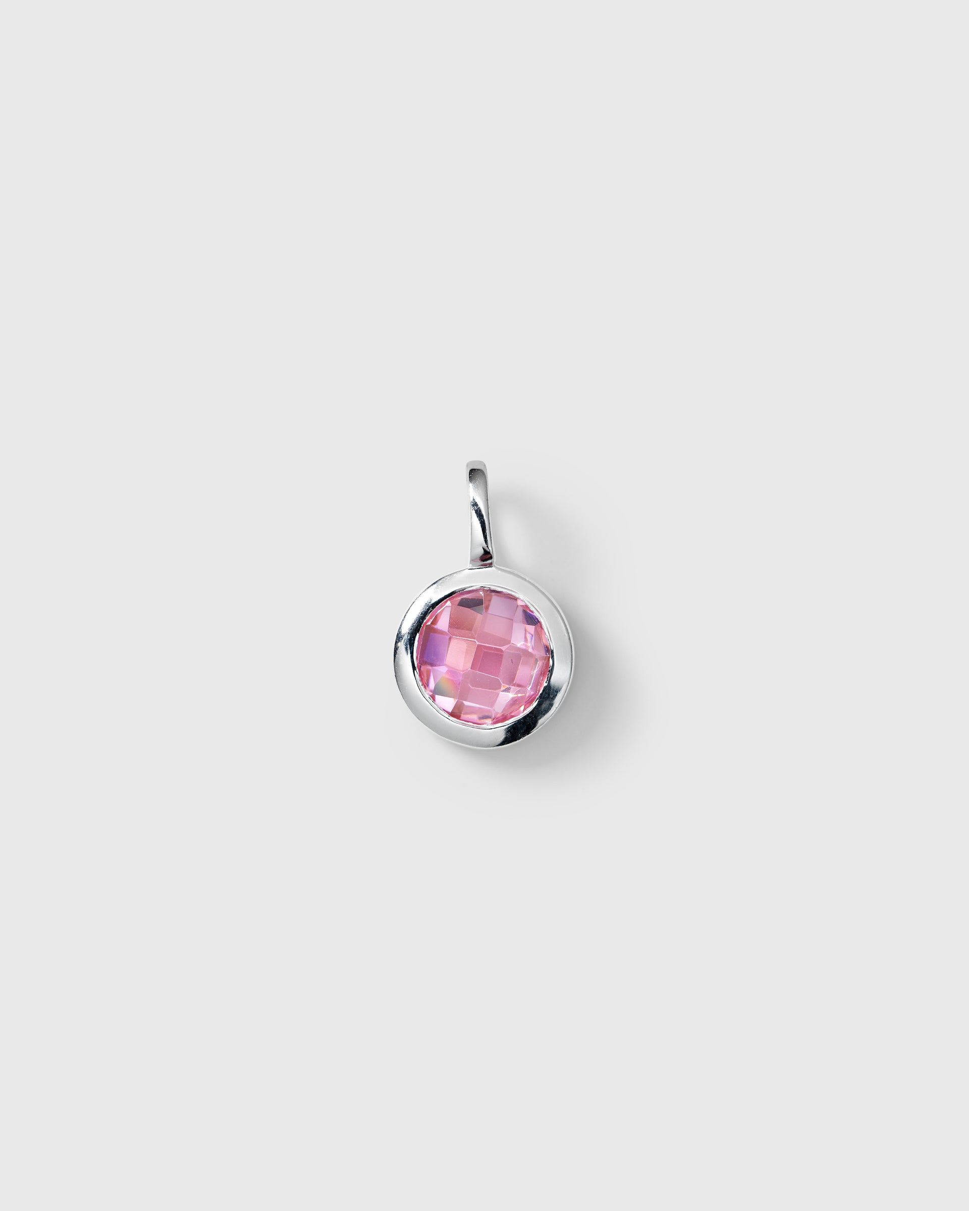 Silver pendant featuring a round faceted pink tourmaline, October birthstone.
