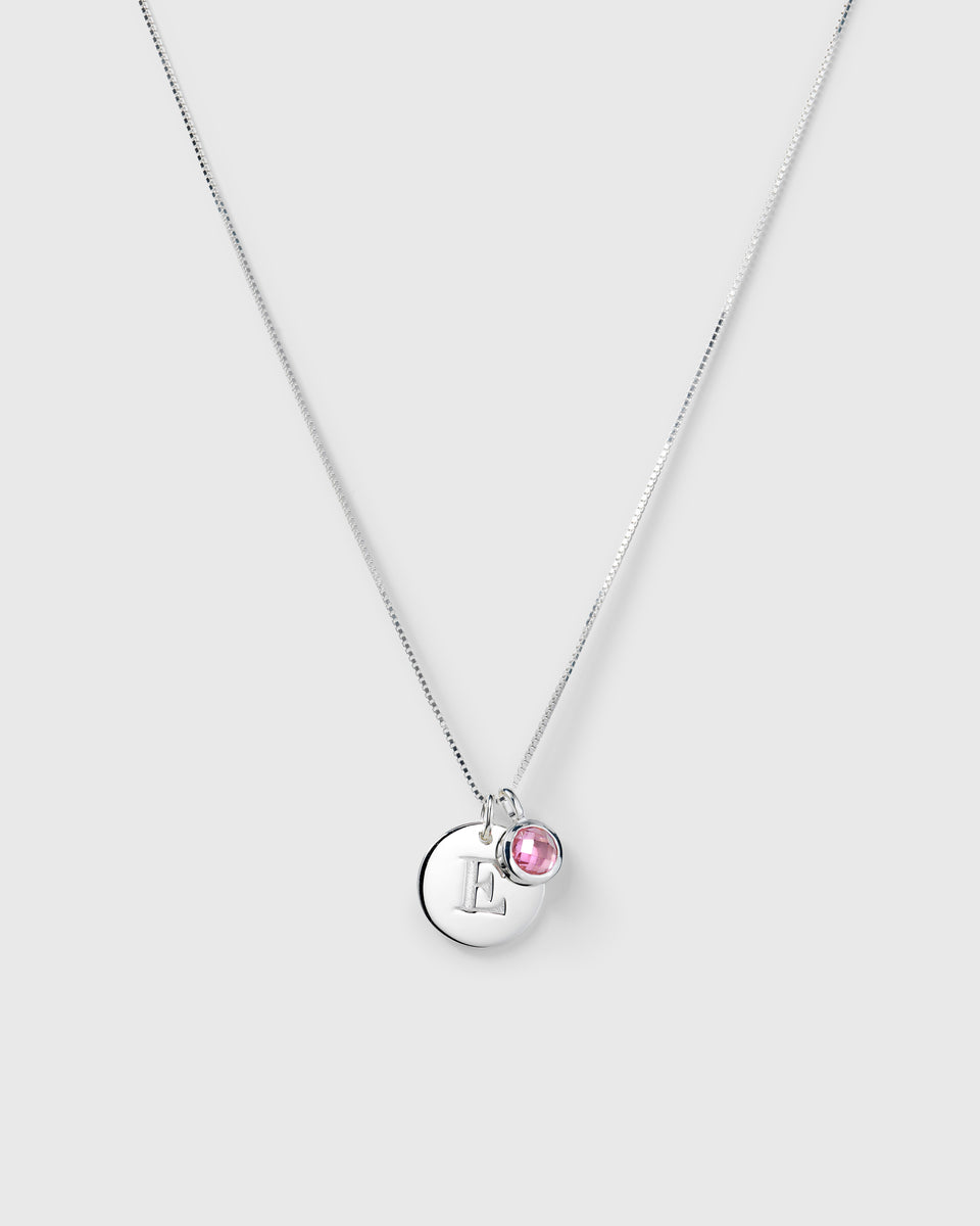 Silver necklace with two pendants: an October birthstone pink tourmaline and a round lettercharm.