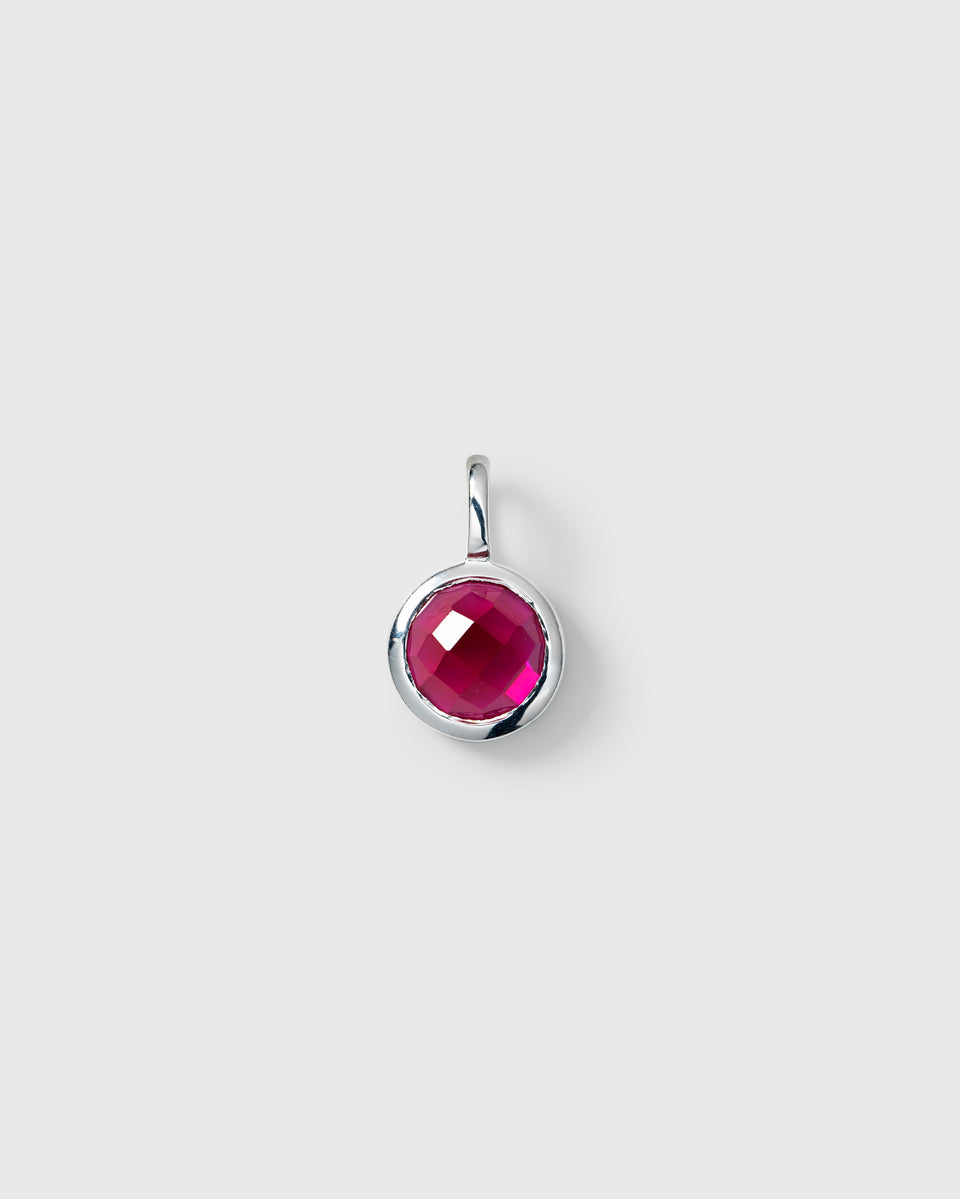 Silver pendant featuring the July birthstone, a round faceted ruby.