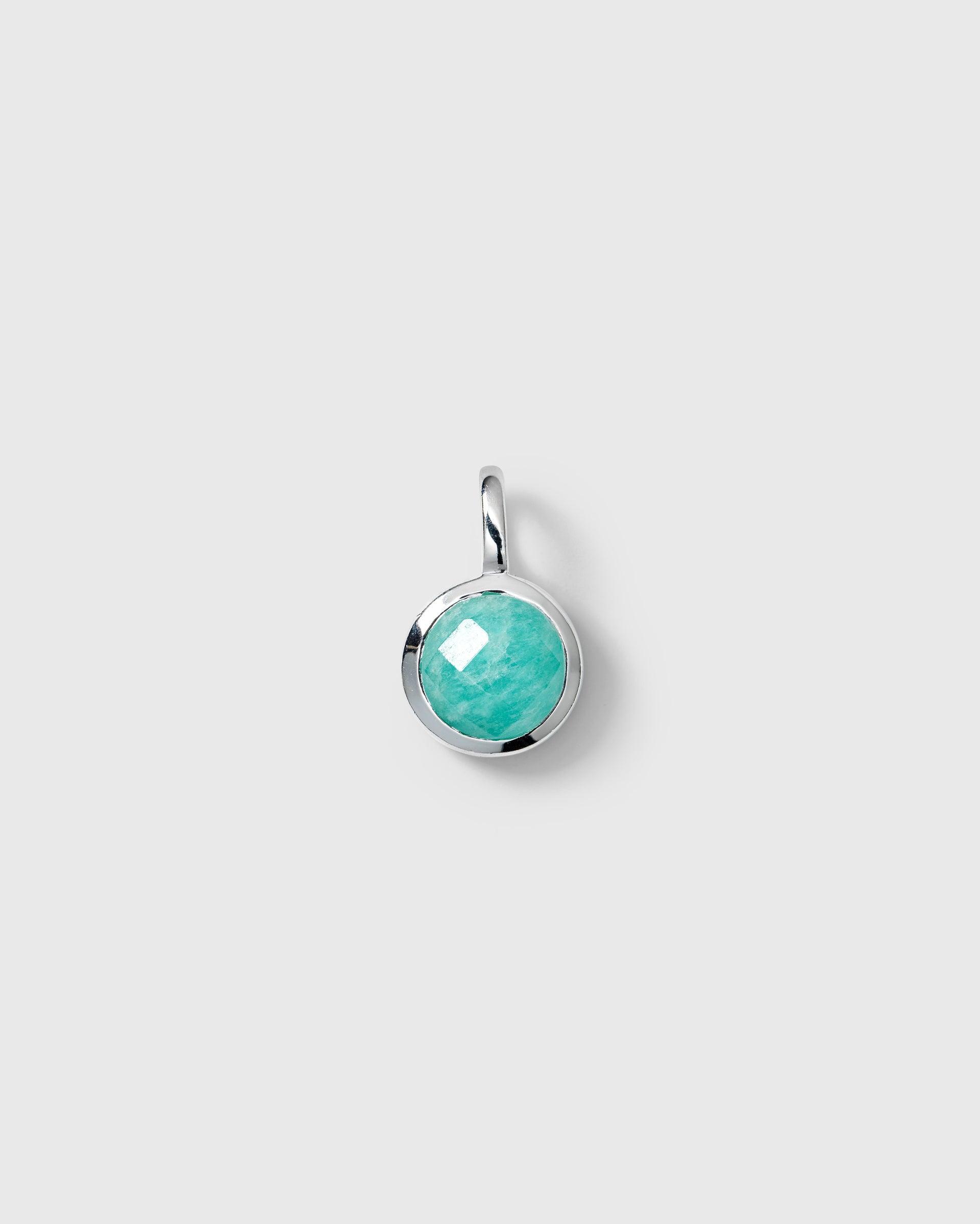 Silver pendant featuring a round faceted turquoise amazonite, December birthstone.