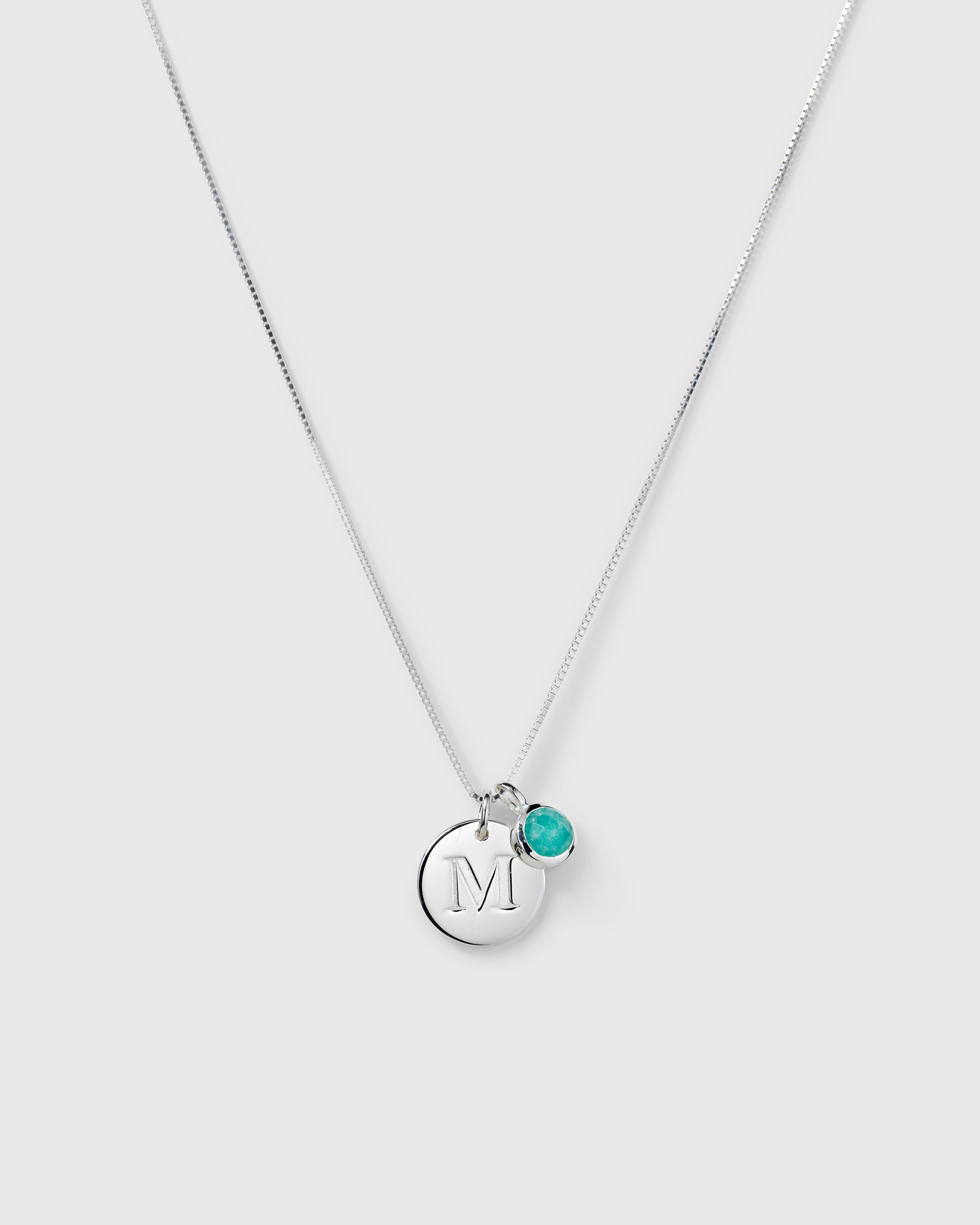 Silver pendant featuring a round faceted turquoise amazonite, December birthstone.
