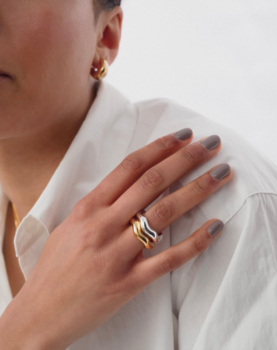 Gold and silver wavy rings stacked together