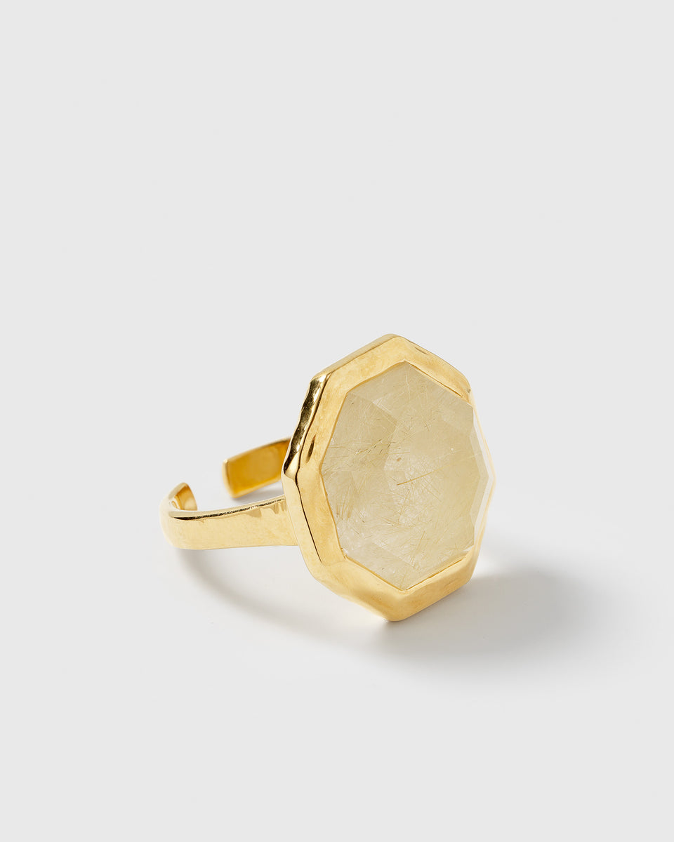 A product shot of the Octagon Ring in gold, featuring a large, octagon-shaped golden rutile stone on an adjustable band.