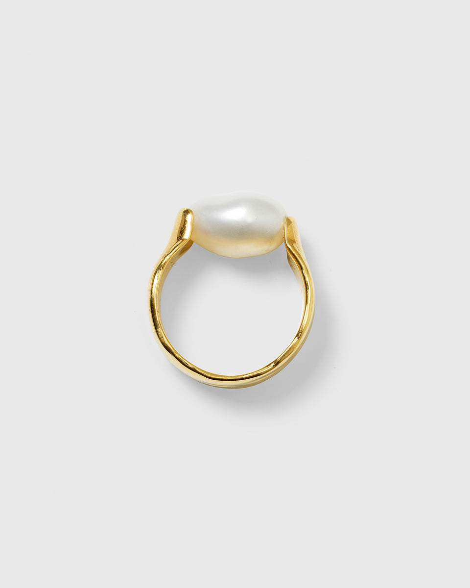The Paxton Ring is handmade from 100% recycled sterling silver, plated with 18K gold and features a unique baroque freshwater pearl.