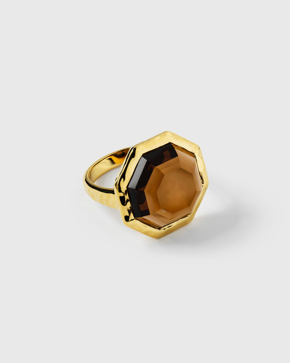 Ring in gold, featuring a large, faceted, octagon-shaped Smokey Quartz stone on a gold band.