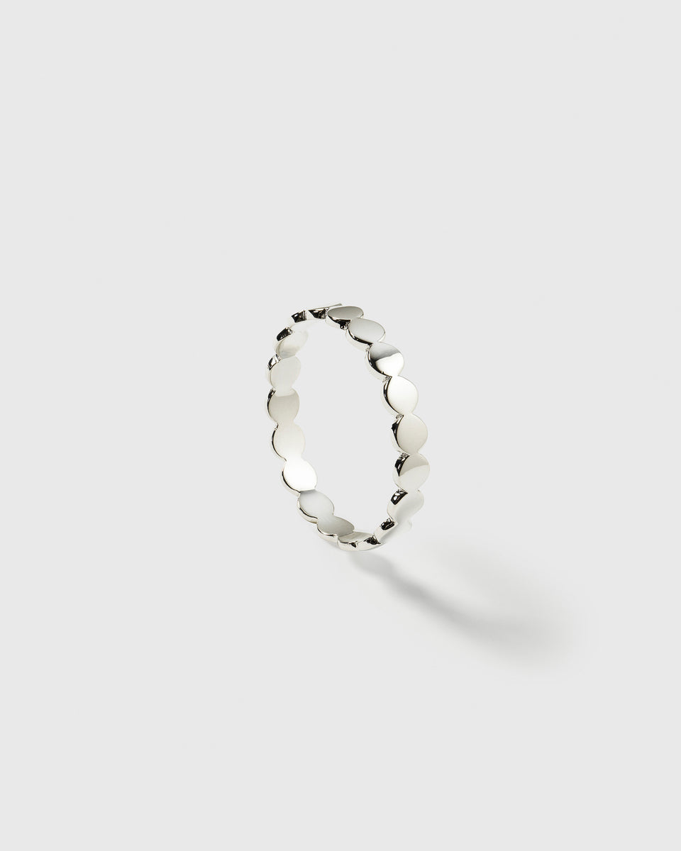 A product shot of the Beaches Flat Dots Ring in silver, showcasing its delicate band made of connected, flat circular dots.
