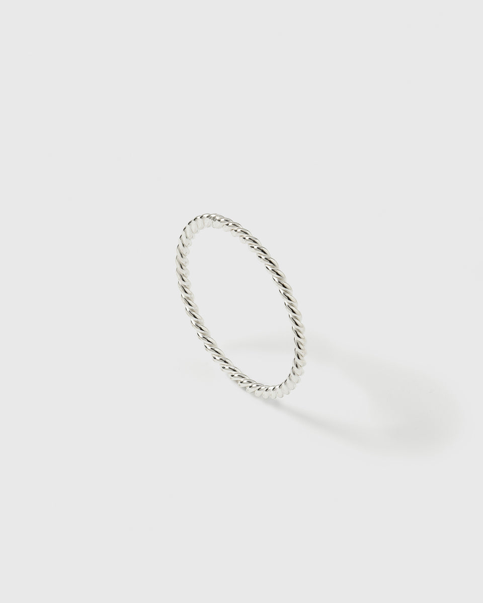 A product shot of the Tiny Twisted Ring in silver, showcasing its delicate, twisted band design.