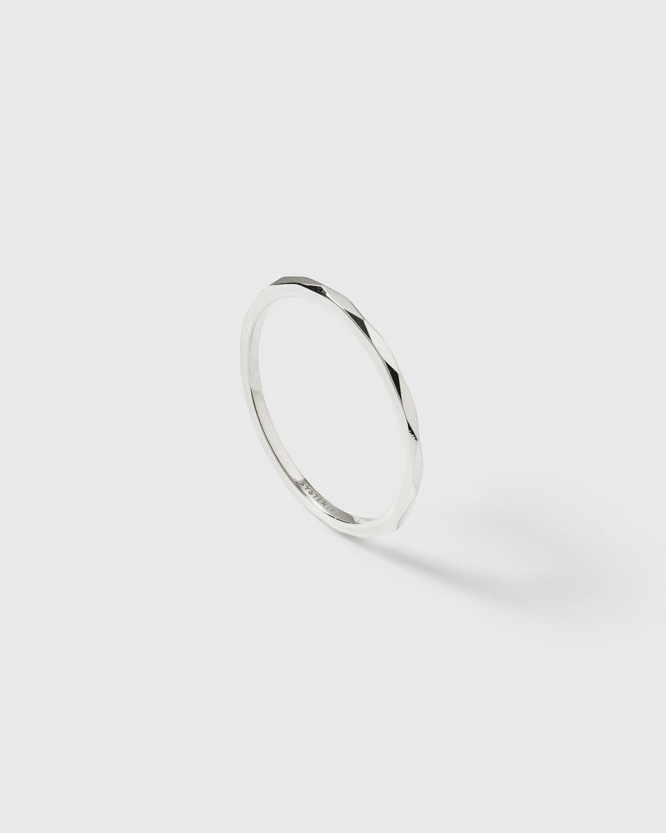 A product shot of the Tiny Ultrathin Ring in silver, highlighting its delicate band and faceted surface.