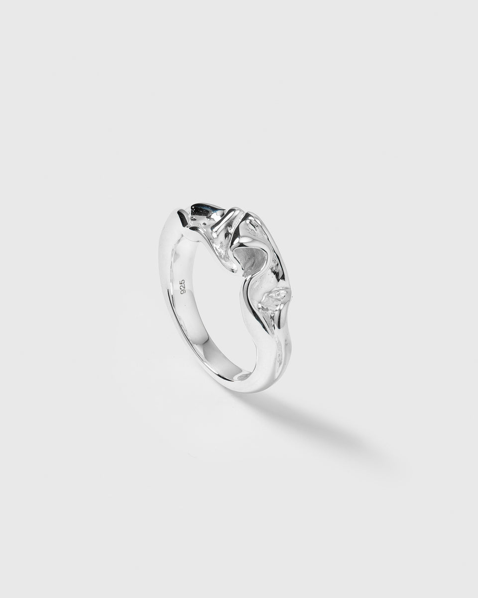 A product shot of the Moulded Narrow Ring in silver, featuring its unique, irregularly shaped design with an organic and textured surface.