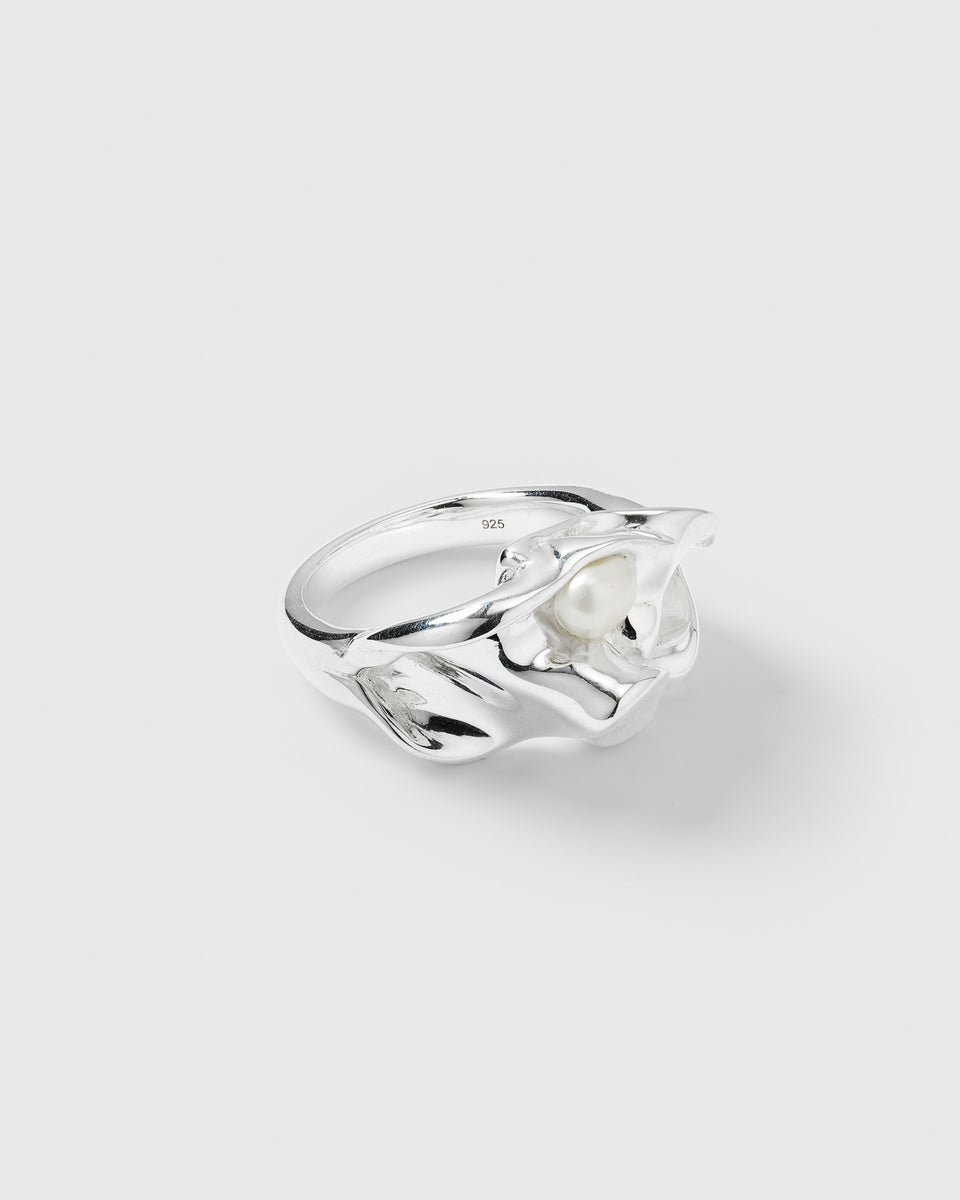 A product shot of the Moulded Big Ring in silver, highlighting its irregular, handcrafted shape and the unique freshwater pearl set within the band.