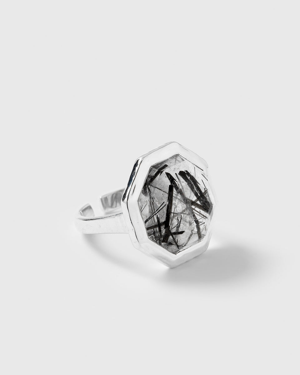 A product shot of the Octagon Ring in silver, featuring a large octagon-shaped black rutile stone.