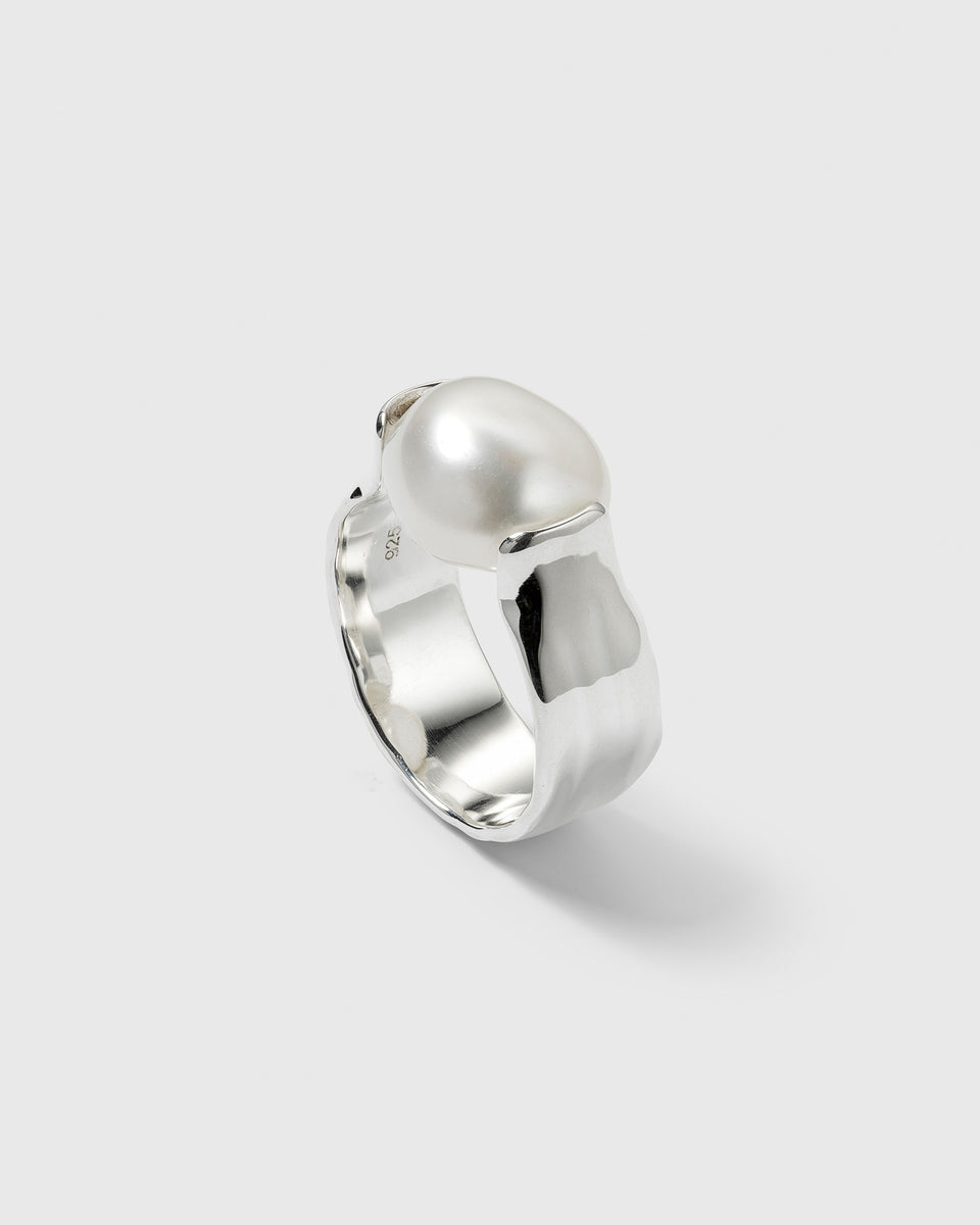 The Paxton Ring in recycled sterling silver, with a hammered band and a large baroque freshwater pearl.