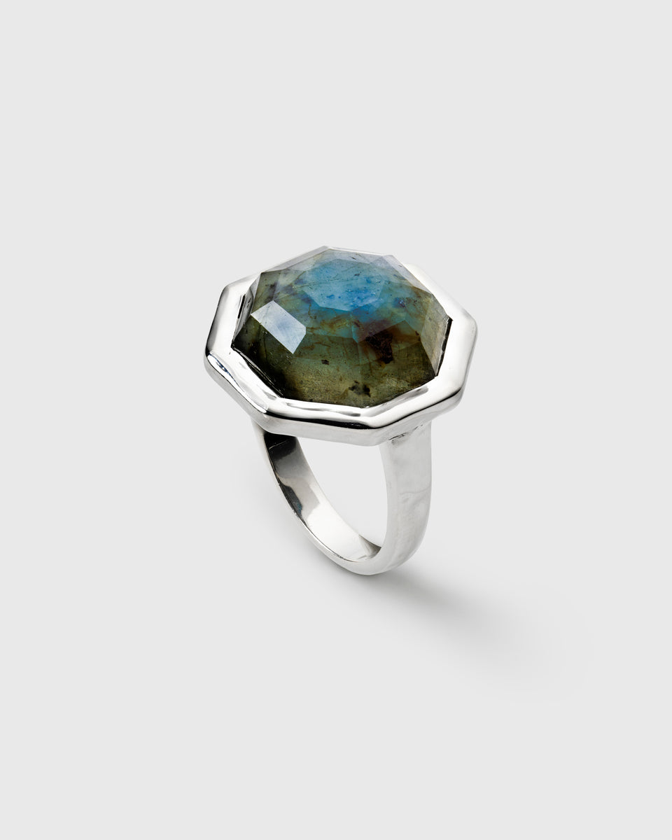 A ring in silver, featuring a large, faceted, octagon-shaped labradorite stone.