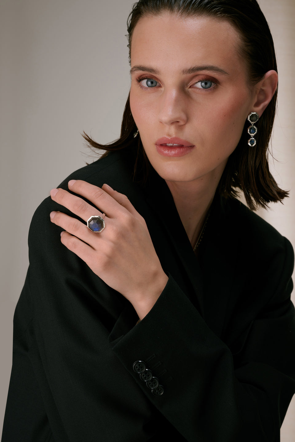 Long  earrings featuring octagon-shaped labradorite stones and a big ring that's match.