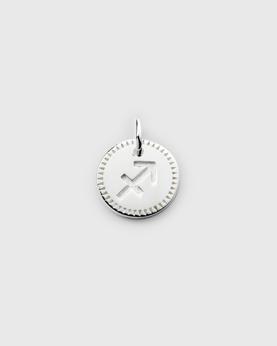 A product shot of the Beloved Zodie Pendant in silver, featuring the engraved Sagittarius zodiac symbol on a round charm with a decorative border.