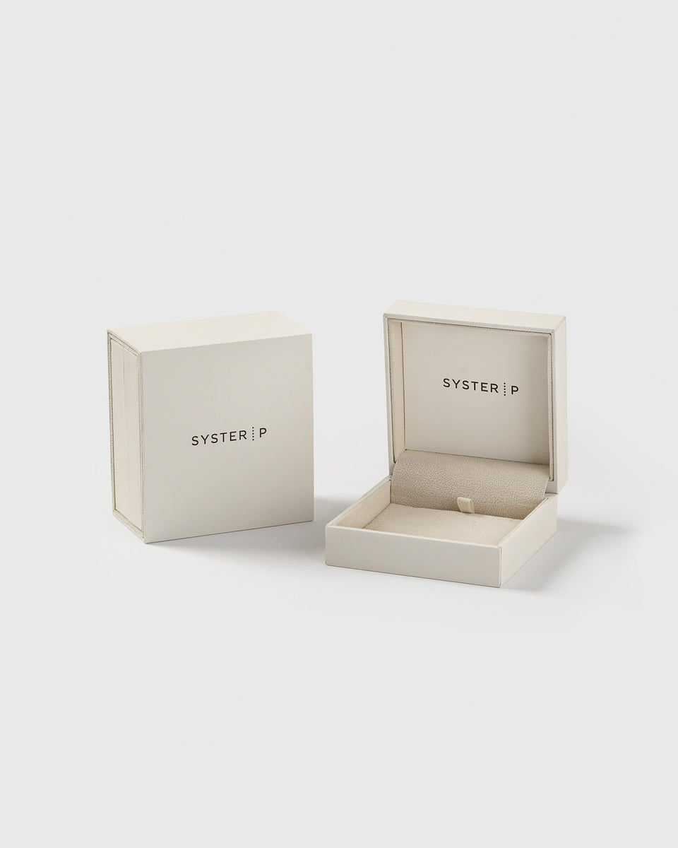 A product shot of the exclusive cream-colored Syster P jewelry box, with one box shown open and the other closed.