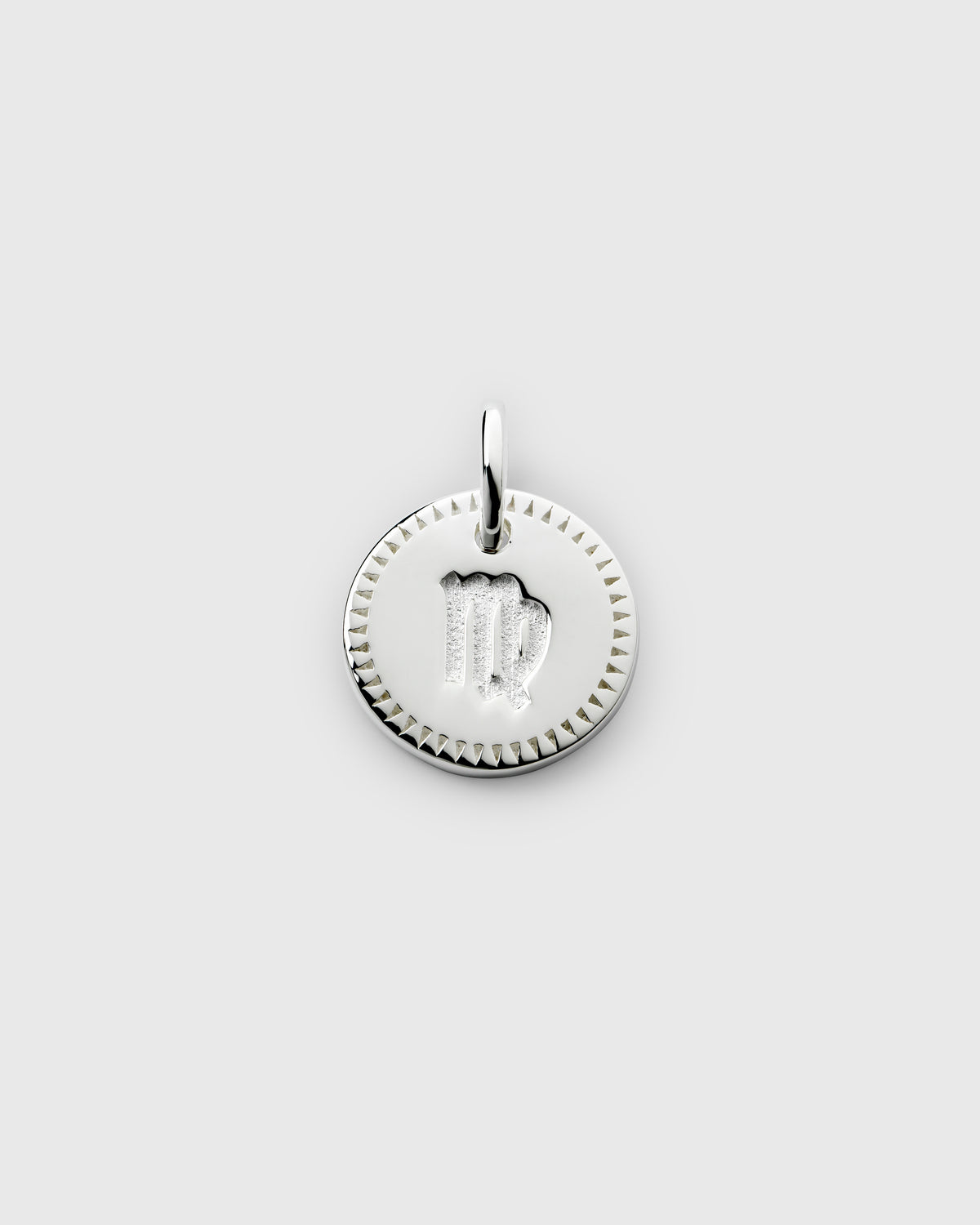 A product shot of the Beloved Zodie Pendant in silver, featuring the Virgo zodiac sign engraved in the center of the circular charm and framed by a decorative border.