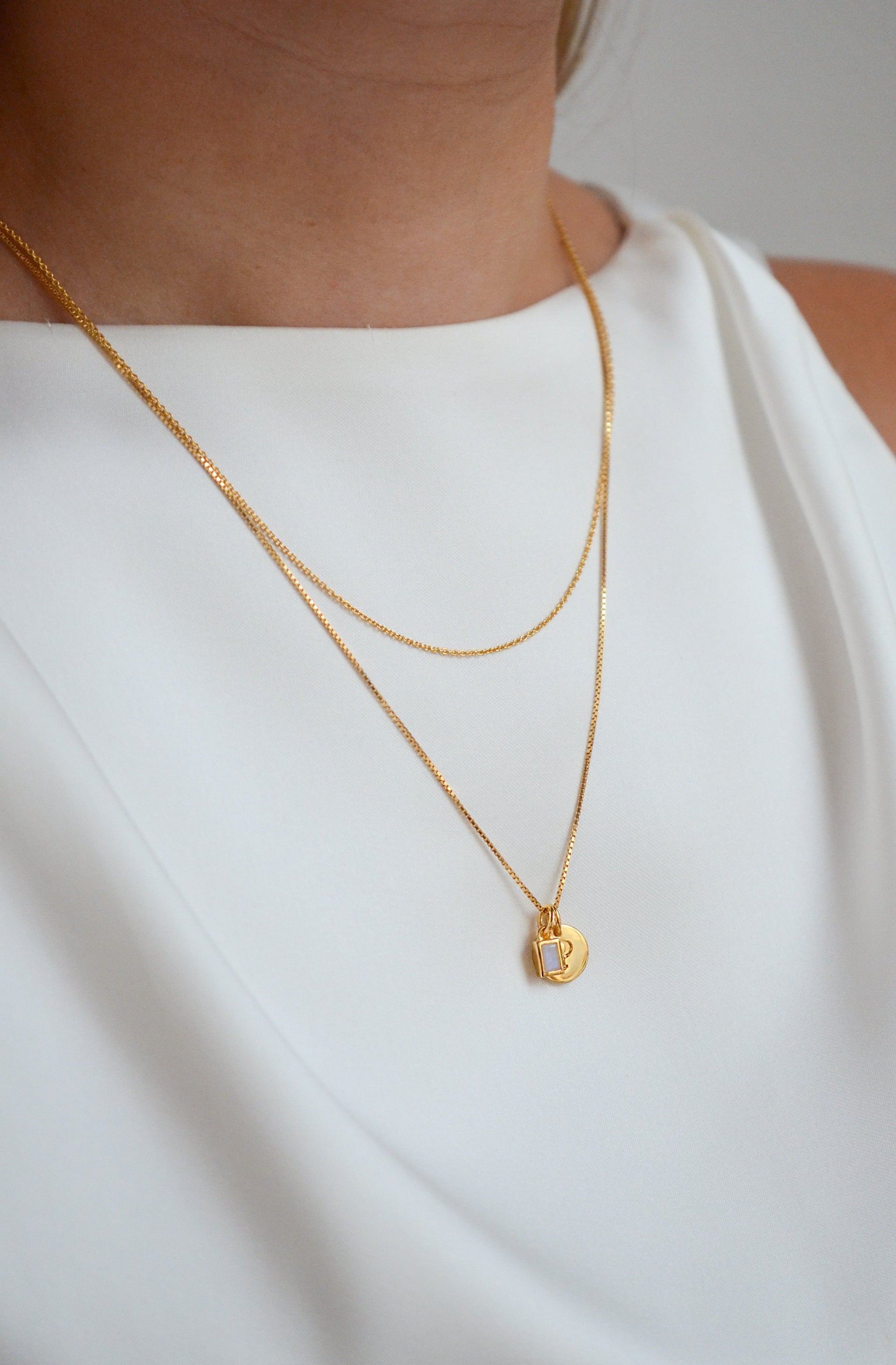 Gold necklaces with letter pendants